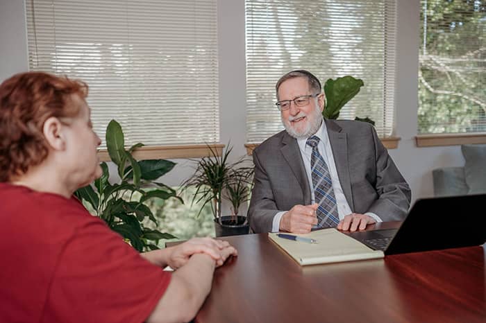 Photo of attorney Bruce Clement meeting with a client